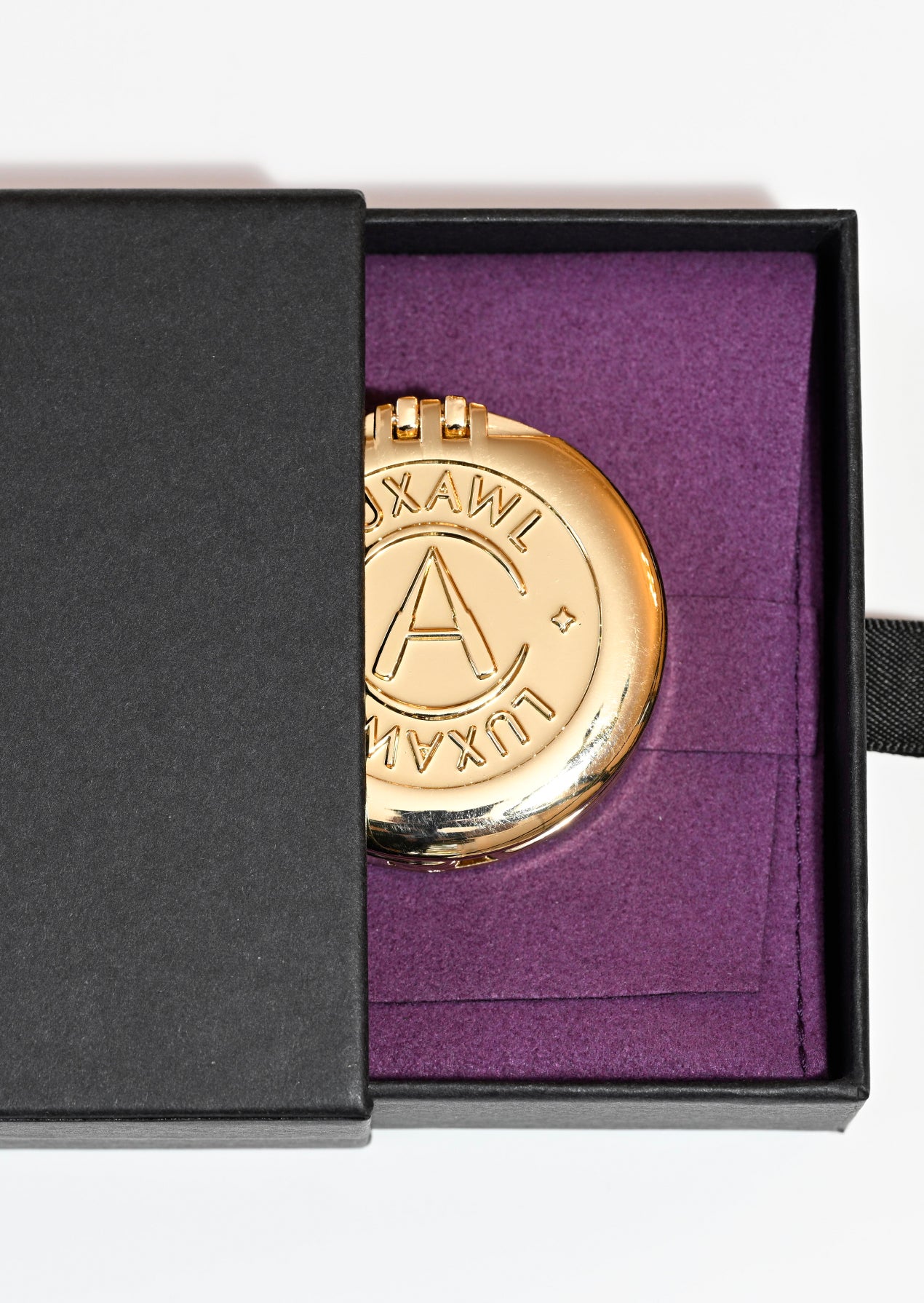 Black box and purple storage pouch for gold bag hook 